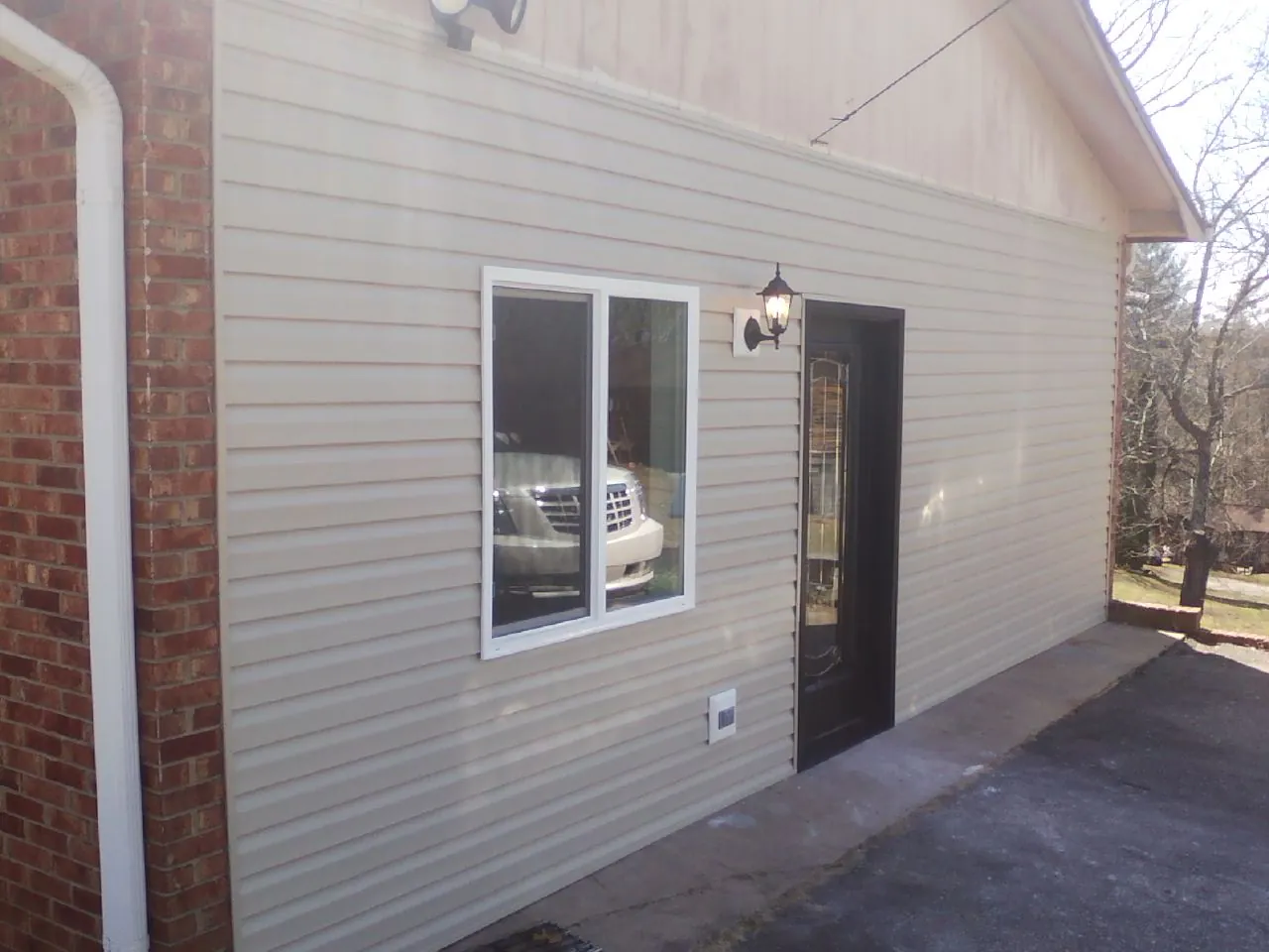 New vinyl siding and entry door on a room addition in Loma
